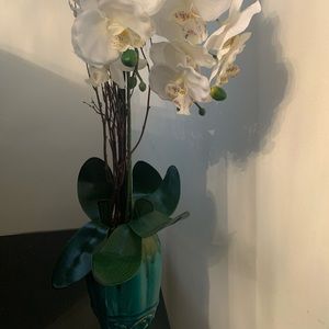 Vase with artificial flower.